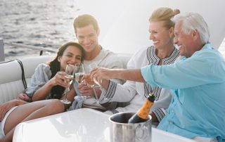 multigeneratonal family making a champagne toast on a boat