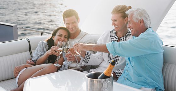 multigeneratonal family making a champagne toast on a boat | spousal lifetime access trust opportunities | Dalby Wendland & Co | CPAs | Advisors | Grand Junction CO | Glenwood Springs CO | Montrose CO 