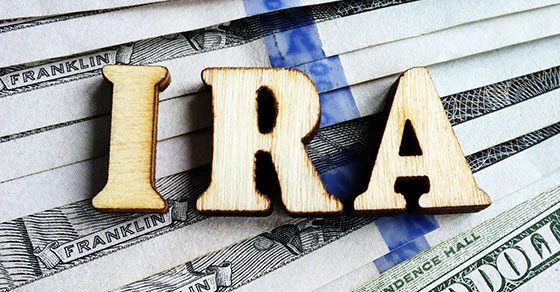 IRA in wood letters sitting on pile of money | Exceptions to the Early Withdrawal Tax Penalty on IRA Distributions | Dalby Wendland & Co. | CPAs adn Advisors | Grand Junction CO | Glenwood Springs CO | Montrose CO