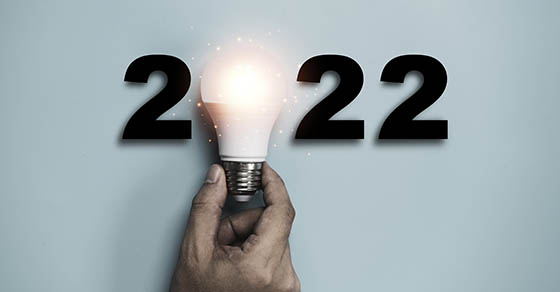 Hand holding a light bulb with year 2022 for new year and creative thinking | year-end tax planning for small businesses | Dalby Wendland & Co. | CPAs and Business Advisors | Grand Junction CO | Glenwood Springs CO | Montrose CO 
